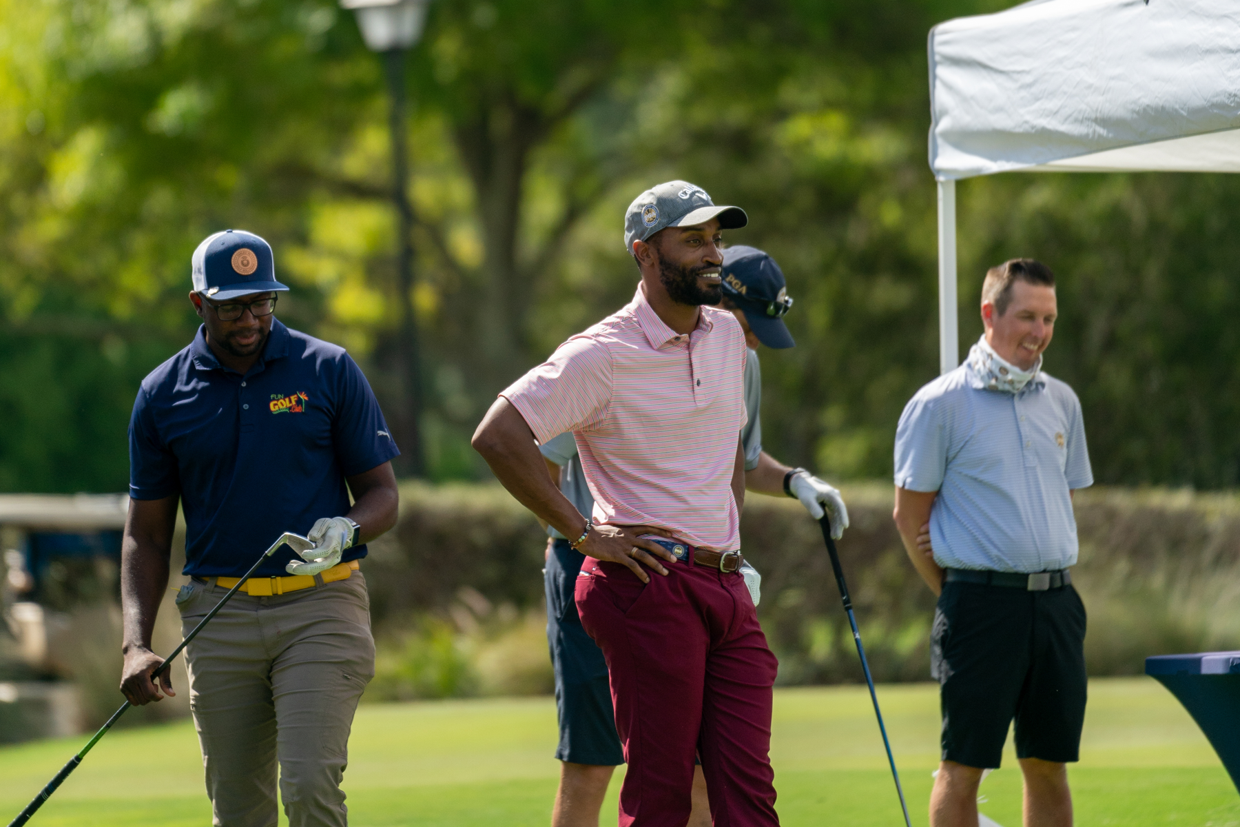 Friends using a golf betting app during a casual weekend round